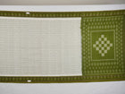 Model wearing a white and green Sambalpuri cotton saree, demonstrating the elegant drape and handloom motifs.