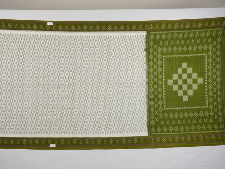 Model wearing a white and green Sambalpuri cotton saree, demonstrating the elegant drape and handloom motifs.