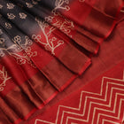 Close-up of the subtle slub and print on a handloom grey and rust Tussar silk saree fabric.