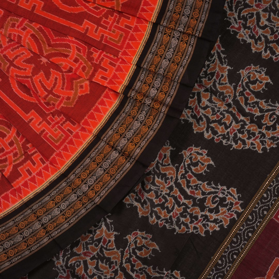 Full flat layout of the orange and black Sambalpuri cotton saree showing the body, border, and pallu
