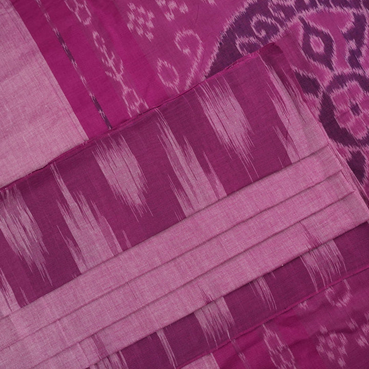 Model draped in a plain pink Sambalpuri cotton saree, styled to show the graceful fall and elegant border.