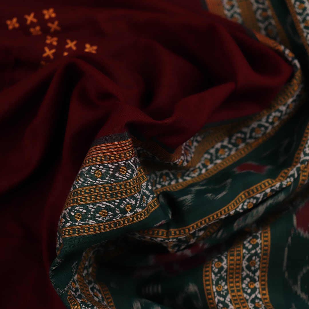 Full view of a maroon and green cotton Bomkai saree with a butta pattern.