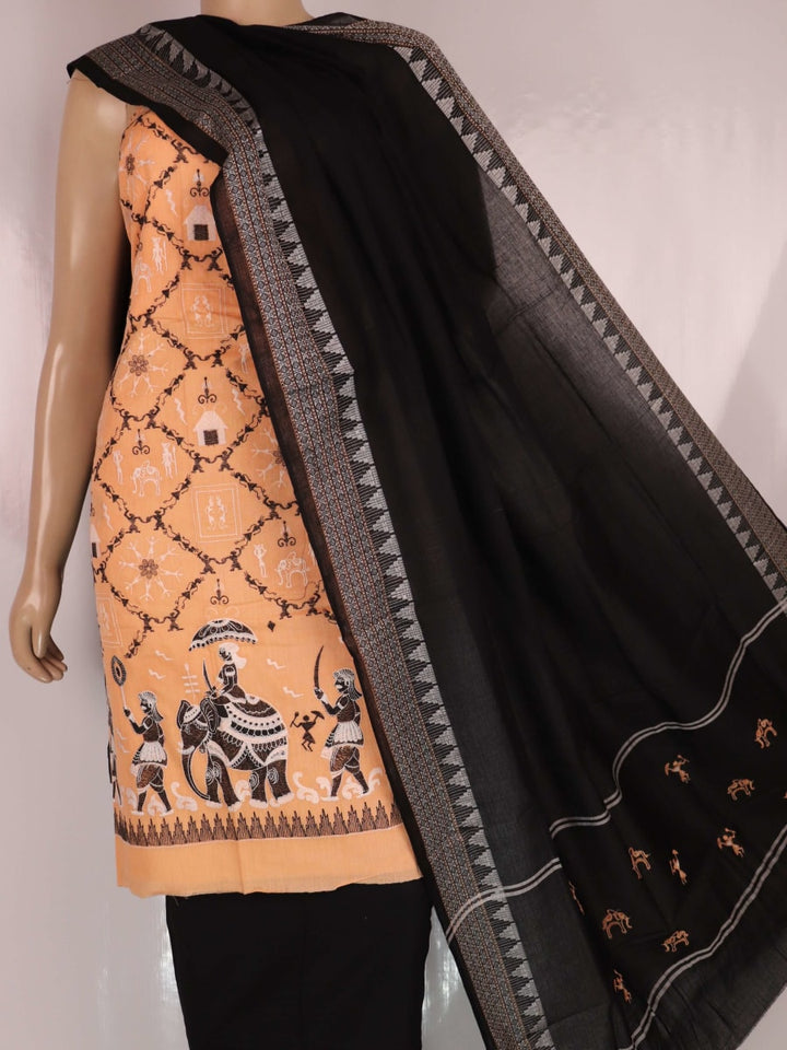 Detailed view of a Sambalpuri cotton dress material in brown and black, showcasing the doll-patterned design on the body.