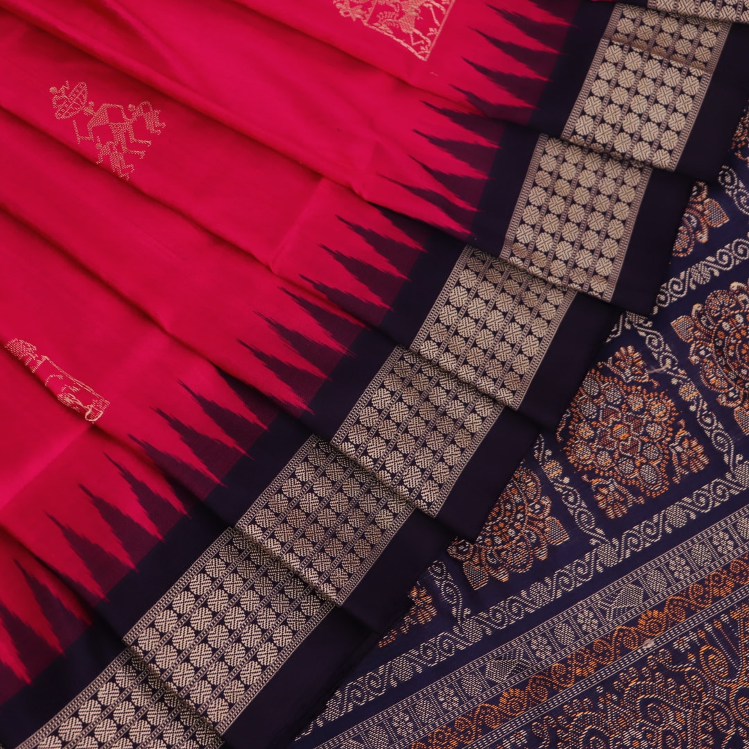 Close-up view of soft, lustrous silk fabric with intricate butta patterns in pink and blue