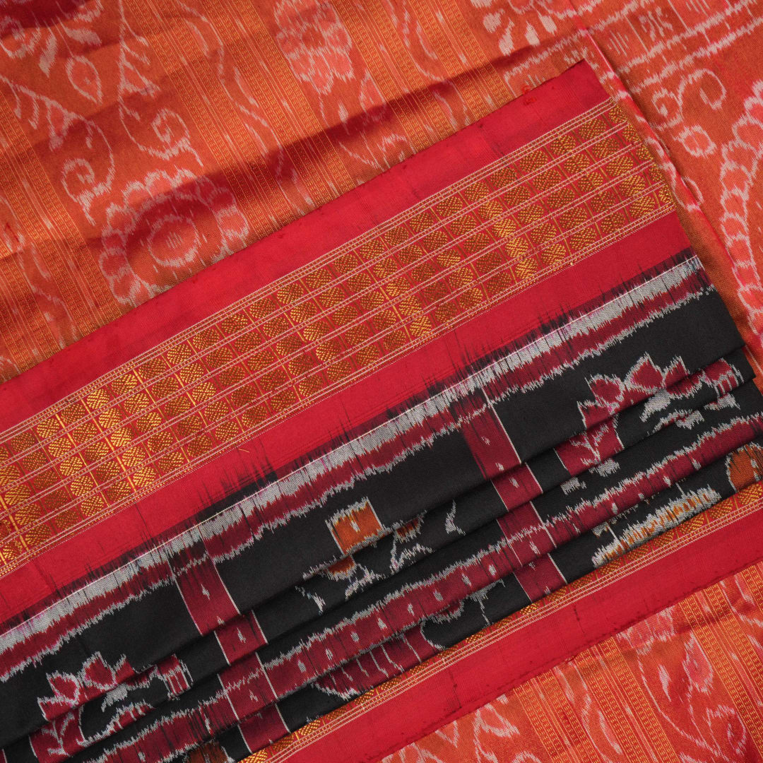 Close-up of Sambalpuri silk saree fabric, revealing rich texture, weave, and subtle tissue motifs.