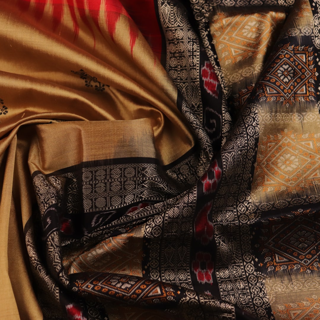 Close-up view of the vibrant and intricate silk fabric texture of a multicolored Bomkai silk saree with a black butta pattern.