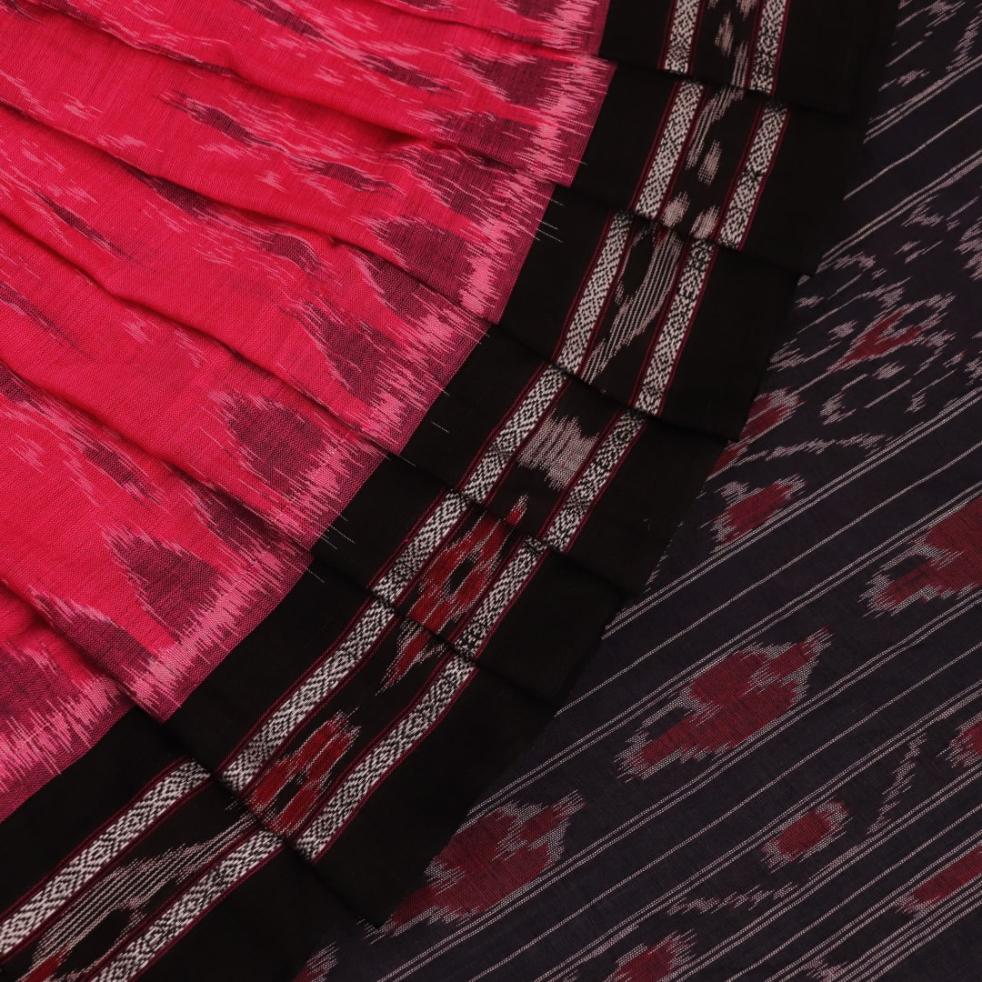 Pink and black cotton Sambalpuri saree with intricate motifs draped in a traditional style.