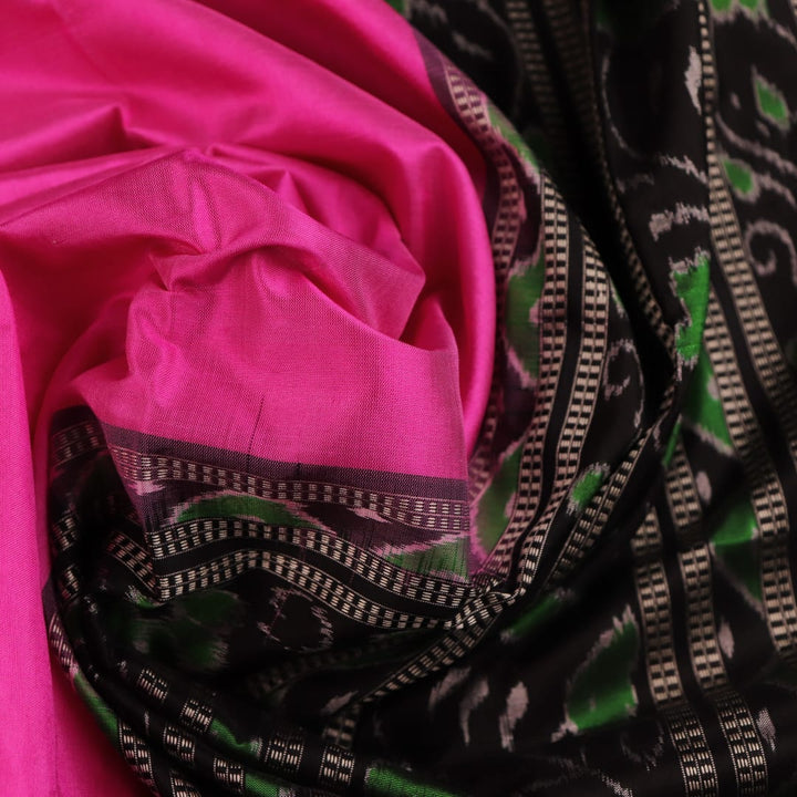 Close-up view of intricate Pasapalli pattern on a shimmering pink and black Sambalpuri silk saree