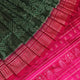 Close-up of textured green Sambalpuri silk saree fabric with magenta motifs.