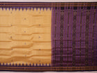 Woman draped in a cream and blue Khandua silk saree with butta pattern, showcasing the elegant drape and styling.