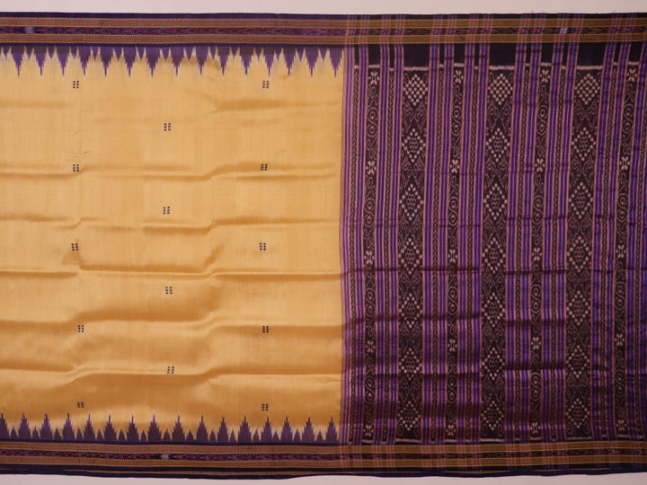 Woman draped in a cream and blue Khandua silk saree with butta pattern, showcasing the elegant drape and styling.