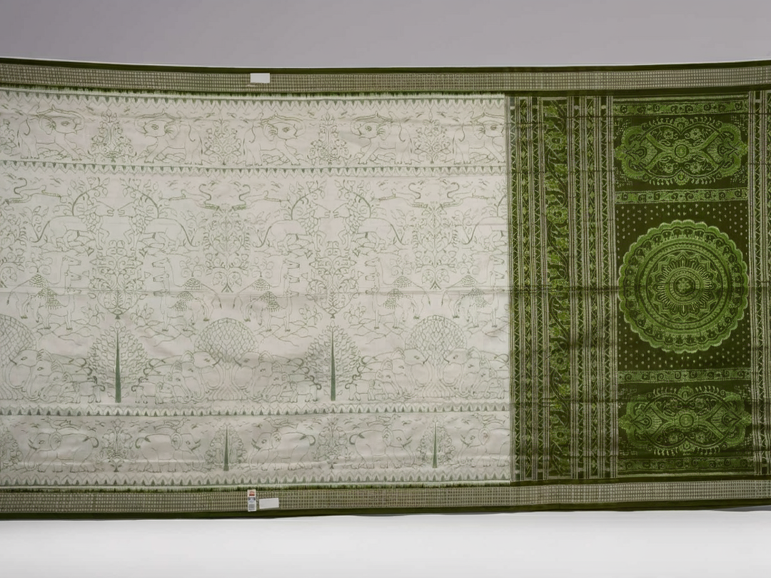 Close-up of the luxurious texture of the white Sambalpuri Silk Saree, revealing the fine weave and motif details.