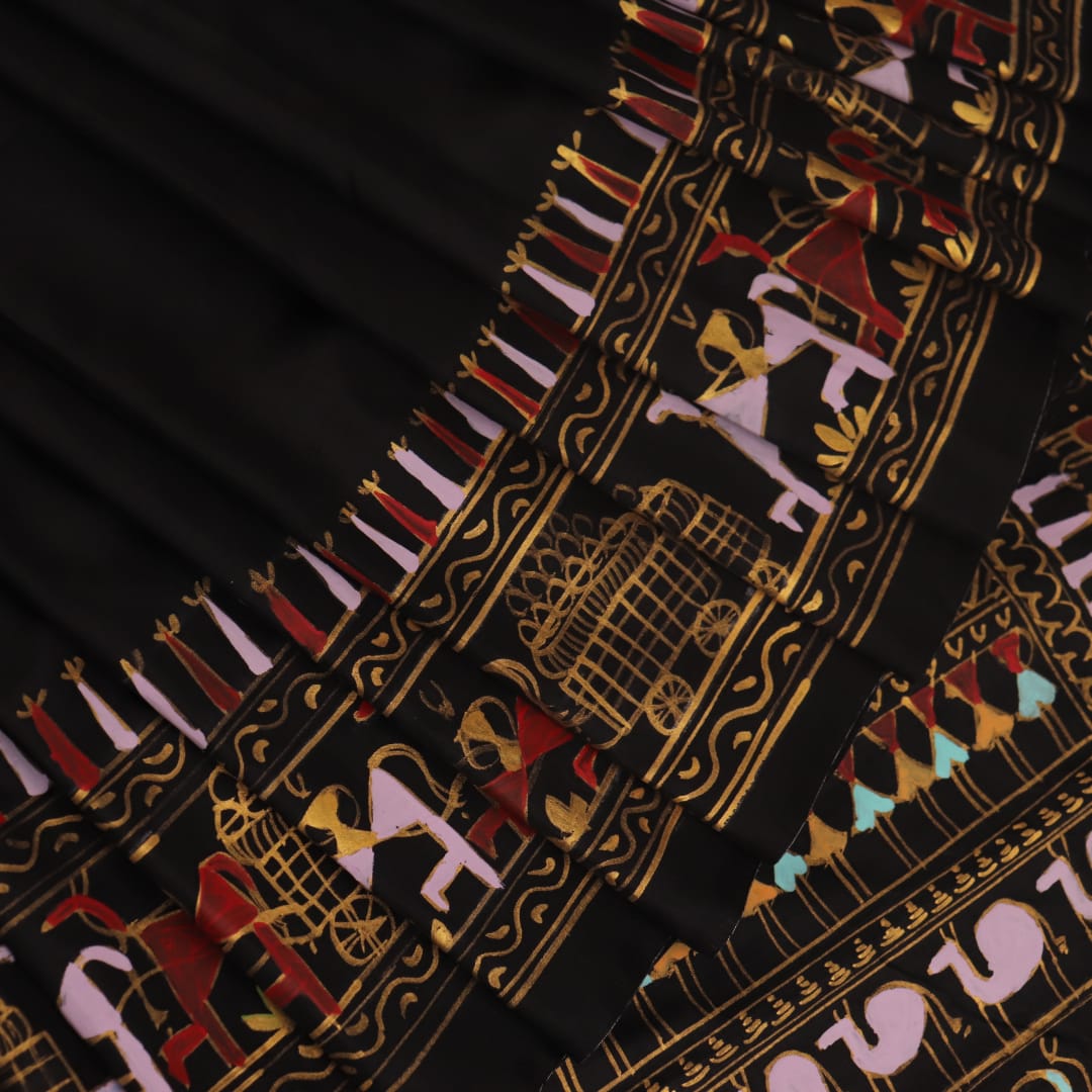 Close-up of the black silk Patachitra saree, showcasing the hand-painted fabric texture.
