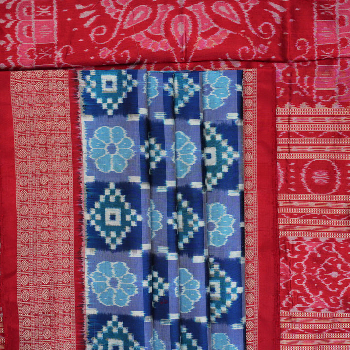Close-up of the luxurious silk fabric texture and distinctive Sambalpuri ikat weave of the blue Pasapalli saree.