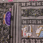Close-up of grey silk Patachitra saree fabric showing hand-painted texture and intricate weave detail.