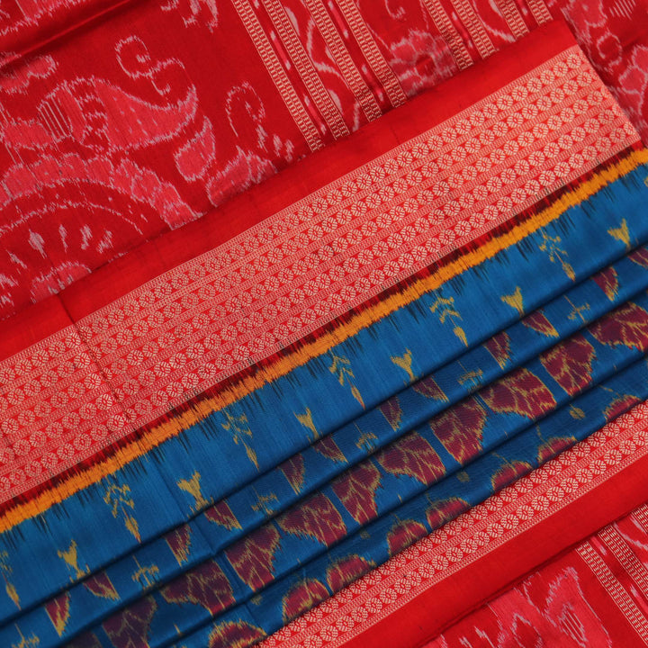 Close-up of blue and orange silk fabric texture with woven motifs