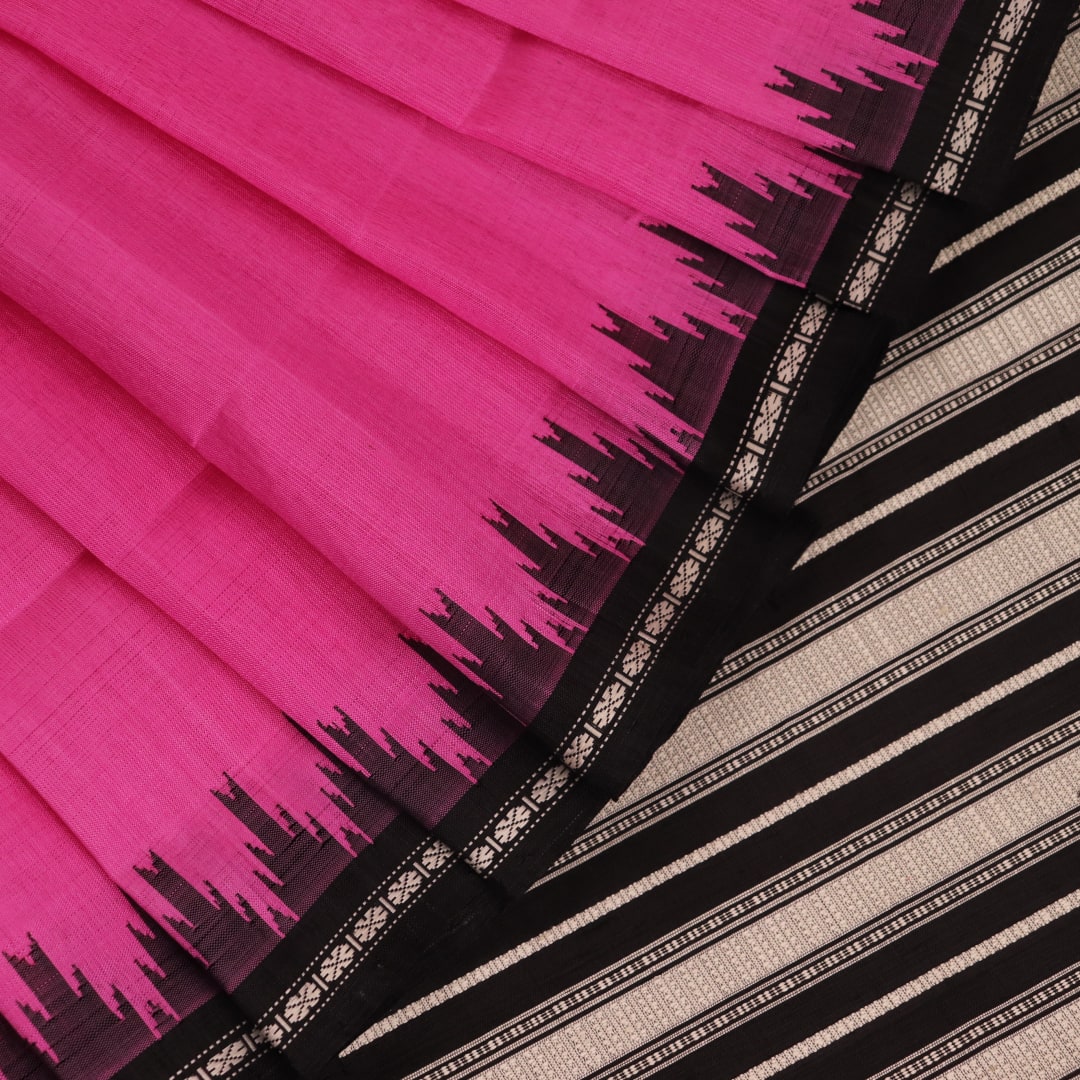 Close-up showcasing the intricate silk fabric texture of a pink and black Berhampuri silk saree with a butta pattern