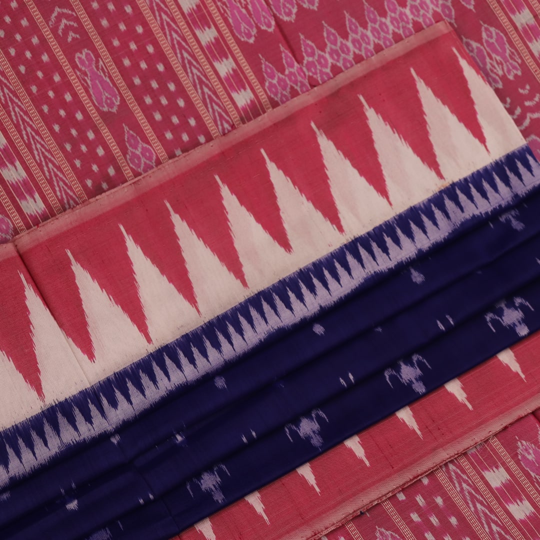 Close-up of soft, shimmering blue and peach silk fabric with intricate Sambalpuri motifs