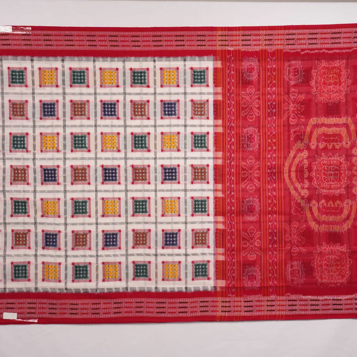 Model wearing a white and red Sambalpuri cotton saree with traditional motifs, styled for an elegant look.