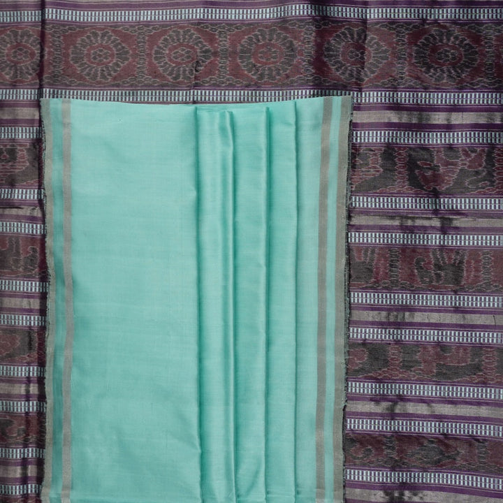 Ultra close-up of the luxurious green Sambalpuri handloom silk weave, highlighting its smooth texture.