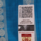 Close-up of the yellow Bomkai silk saree fabric texture, revealing its intricate weave and butta pattern.