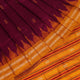 Close-up fabric texture of a magenta Sambalpuri Silk Saree with yellow butta pattern.
