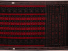 Red and black Sambalpuri cotton saree draped, showcasing overall styling and motifs.
