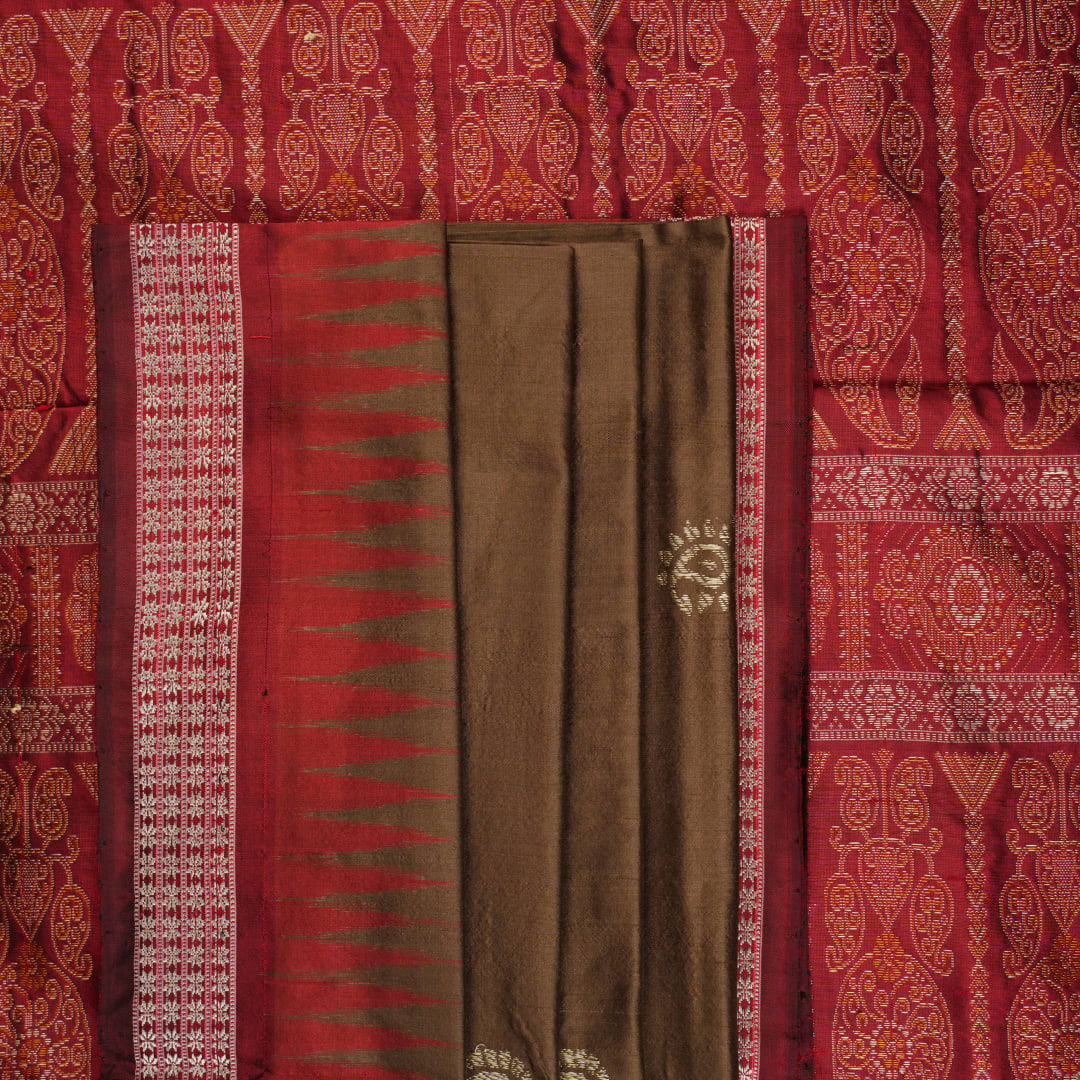 Close-up of Bomkai Silk Saree fabric, highlighting its luxurious brown silk texture and intricate weave.