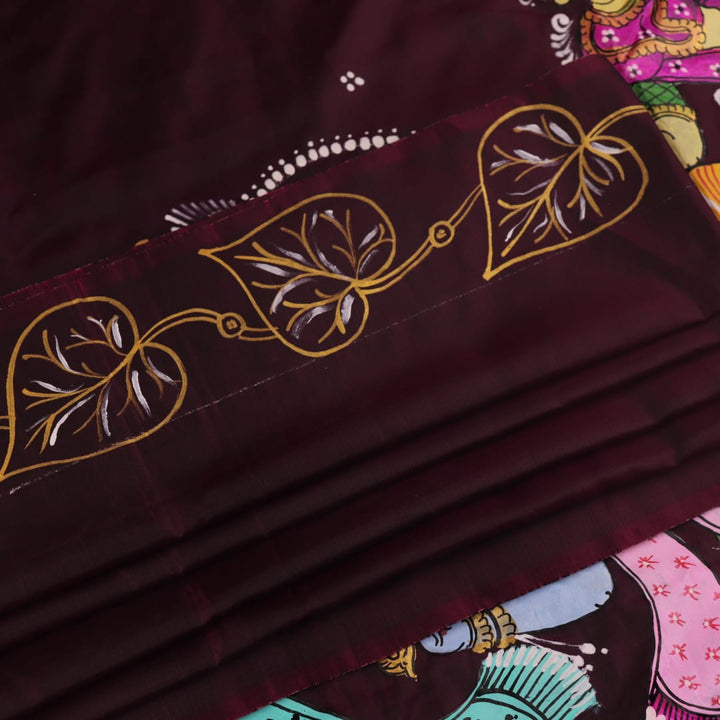 Close-up of a hand-painted silk Patachitra saree, highlighting the vibrant, textured weave and intricate details.