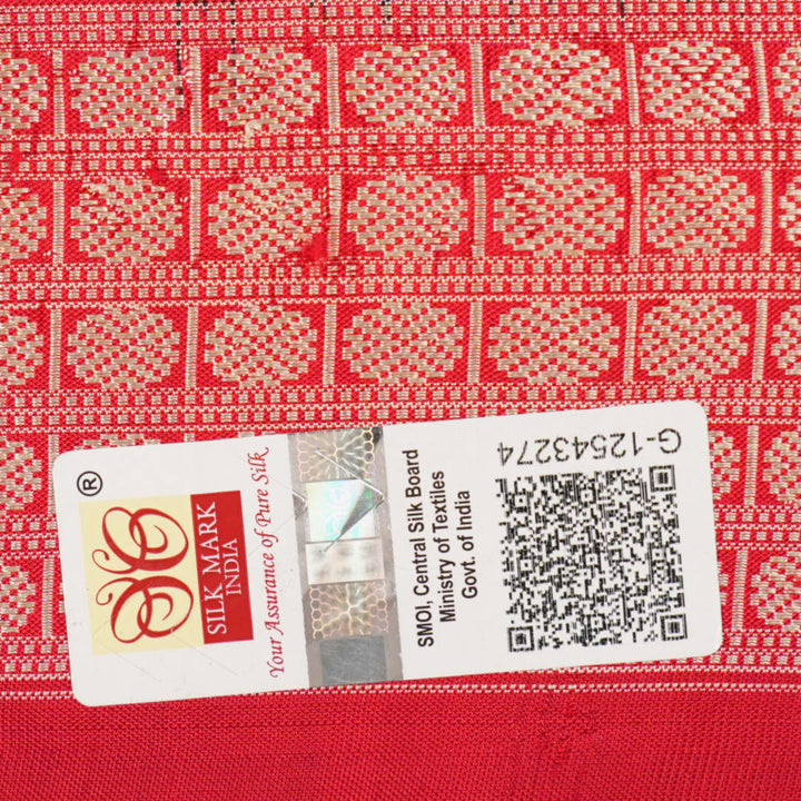 Close-up of the rich, smooth texture of the black Sambalpuri silk saree fabric.