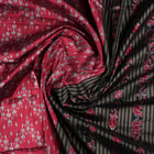 Detailed close-up of the maroon and black Sambalpuri silk saree's luxurious fabric texture and weave.