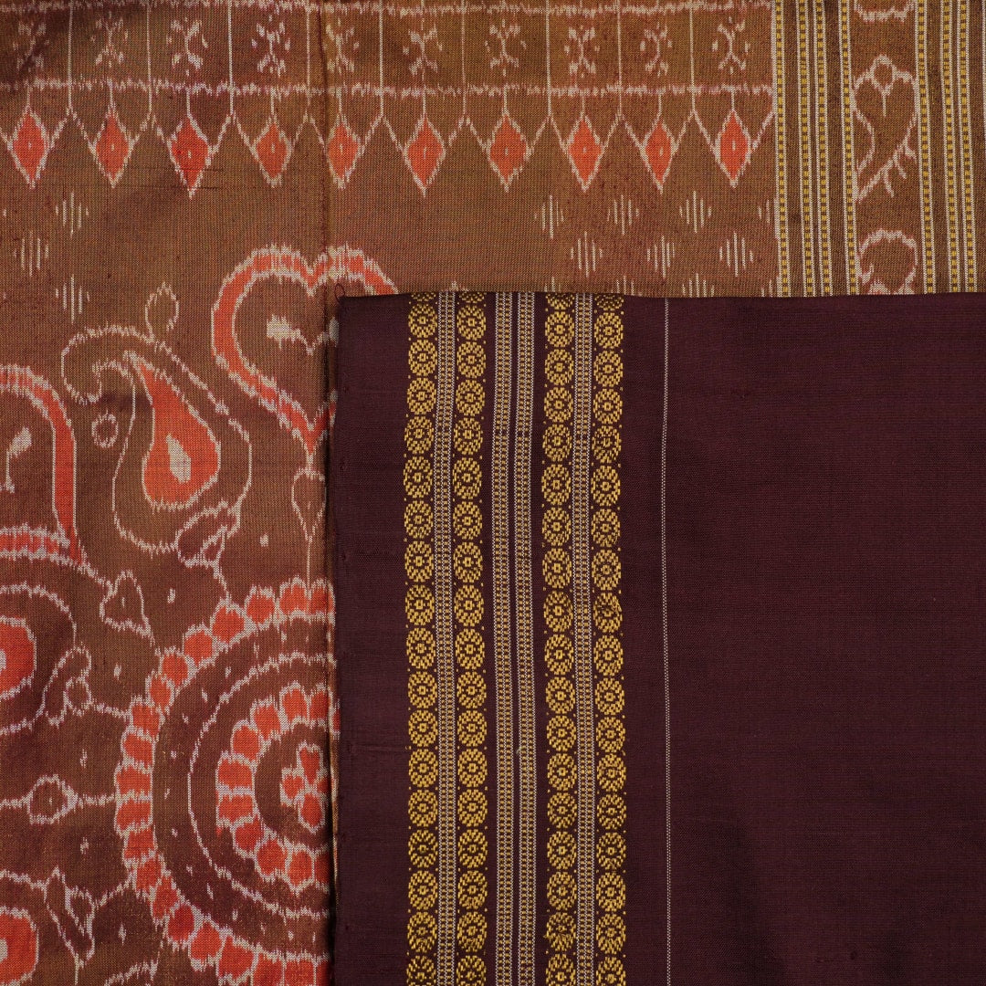 Close-up of Sambalpuri silk fabric texture, highlighting the fine weave in pink and maroon with delicate tissue motifs.