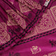 Close-up of magenta Tussar silk saree fabric, showing the printed pattern and natural slub texture.