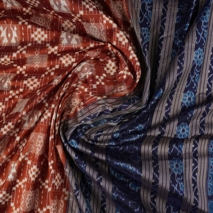 Close-up of the rich silk fabric texture of the Sambalpuri Saree, showing the intricate weave and slight sheen.