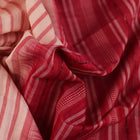 Entire white and maroon striped Sambalpuri cotton saree laid out.