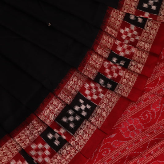 Close-up of black and red silk saree fabric with intricate Sambalpuri motifs