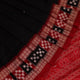 Close-up of black and red silk saree fabric with intricate Sambalpuri motifs
