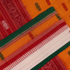 Full view of a white and green cotton handloom Bomkai saree with butta pattern.