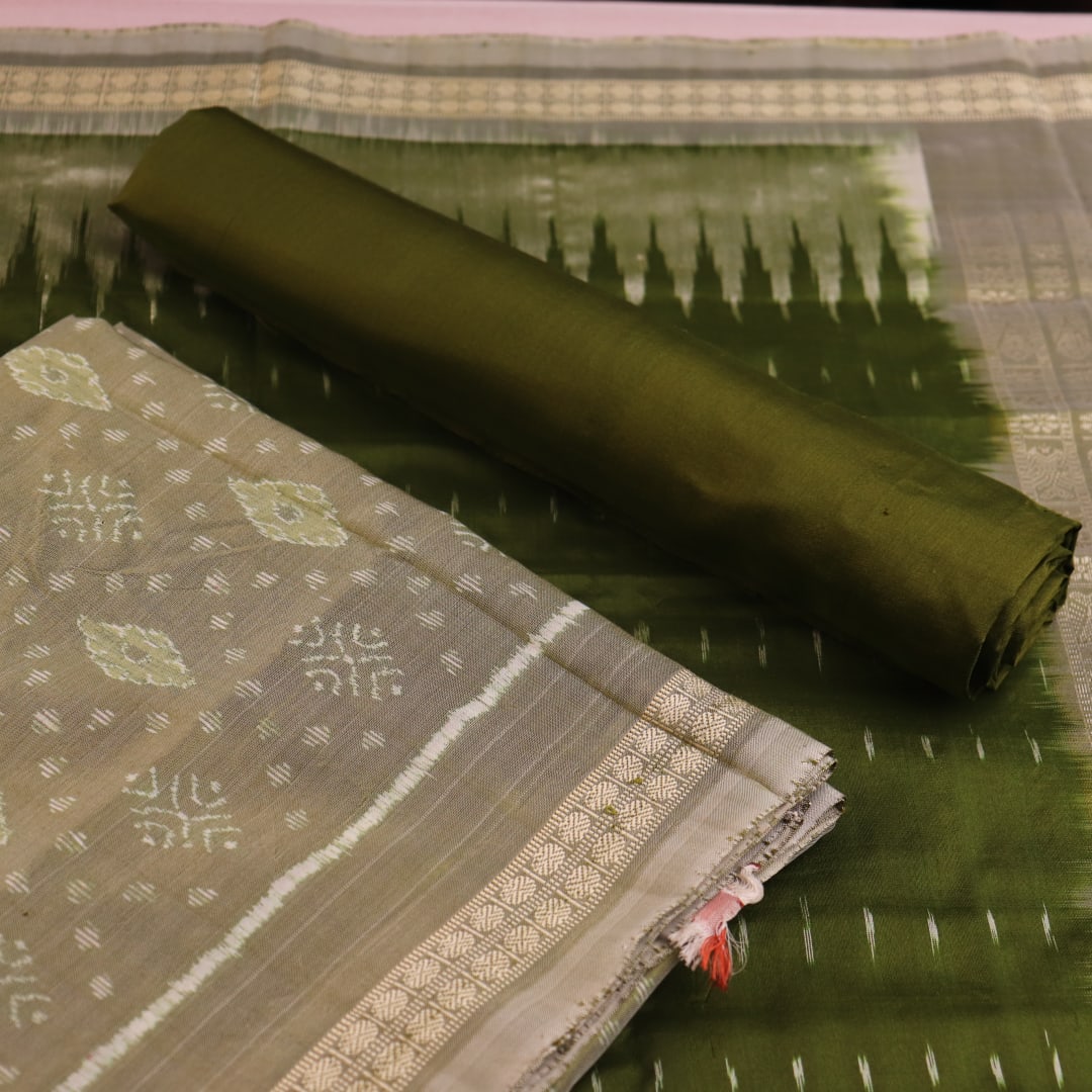 Detail of green Bomkai silk dress material's blouse piece with intricate motifs.