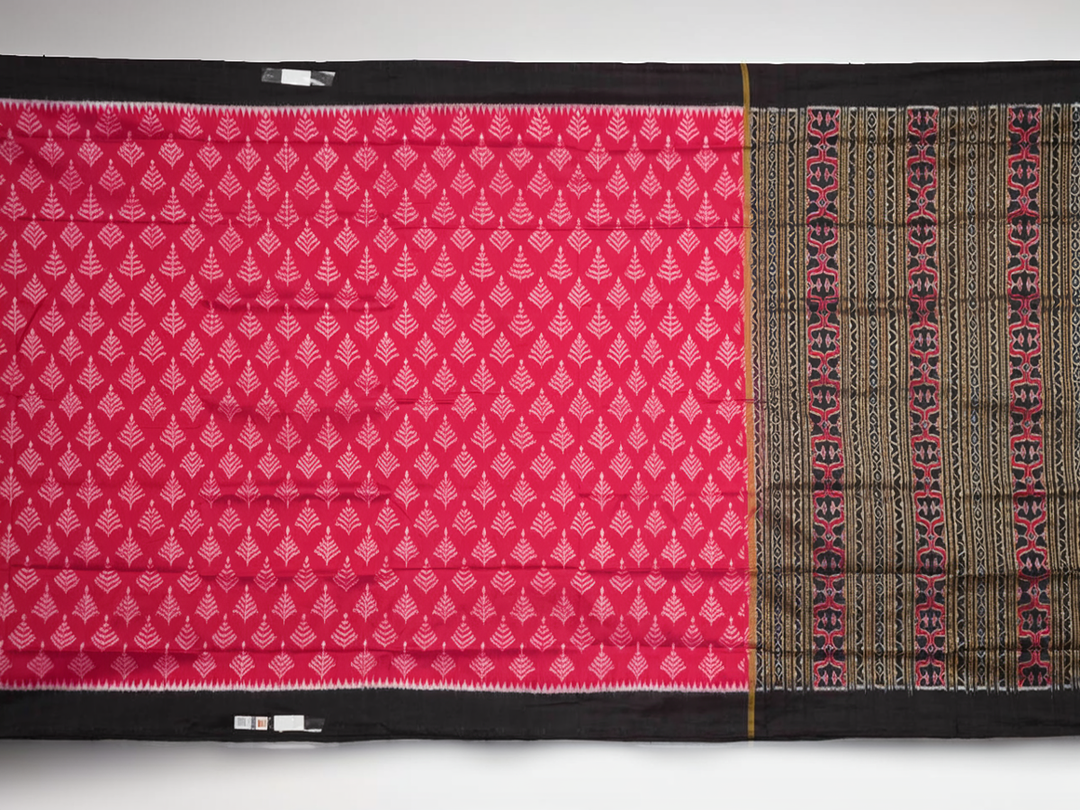 Close-up of the luxurious, handloom silk texture of the red Sambalpuri saree, showing the weave.