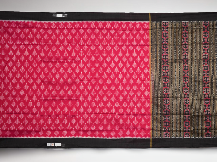 Close-up of the luxurious, handloom silk texture of the red Sambalpuri saree, showing the weave.