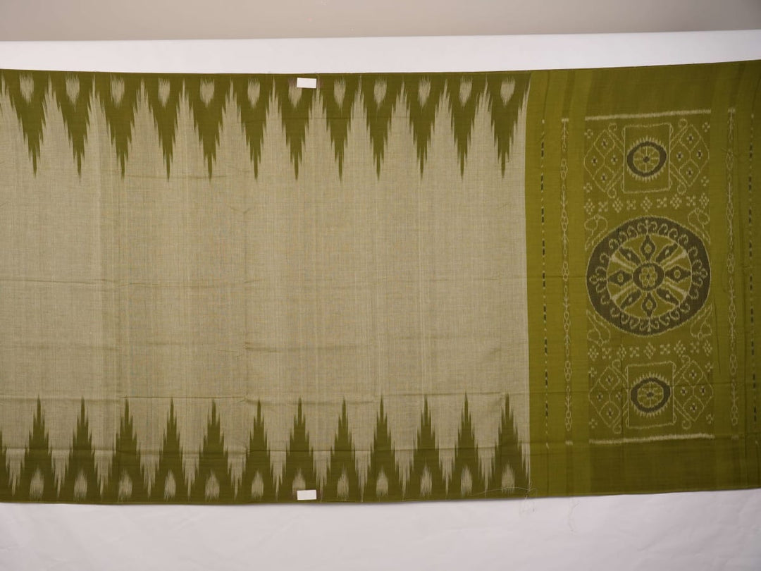 Full styling view of a model draped in a plain green Sambalpuri cotton saree with traditional accents.