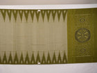 Full styling view of a model draped in a plain green Sambalpuri cotton saree with traditional accents.