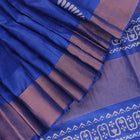 Close-up of blue printed Tussar silk handloom saree fabric texture.
