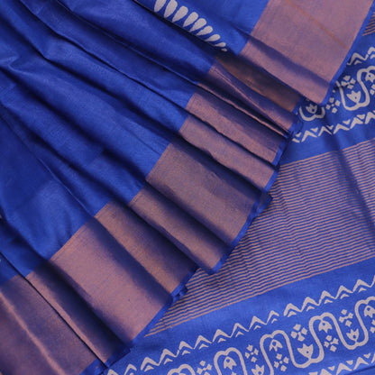 Close-up of blue printed Tussar silk handloom saree fabric texture.