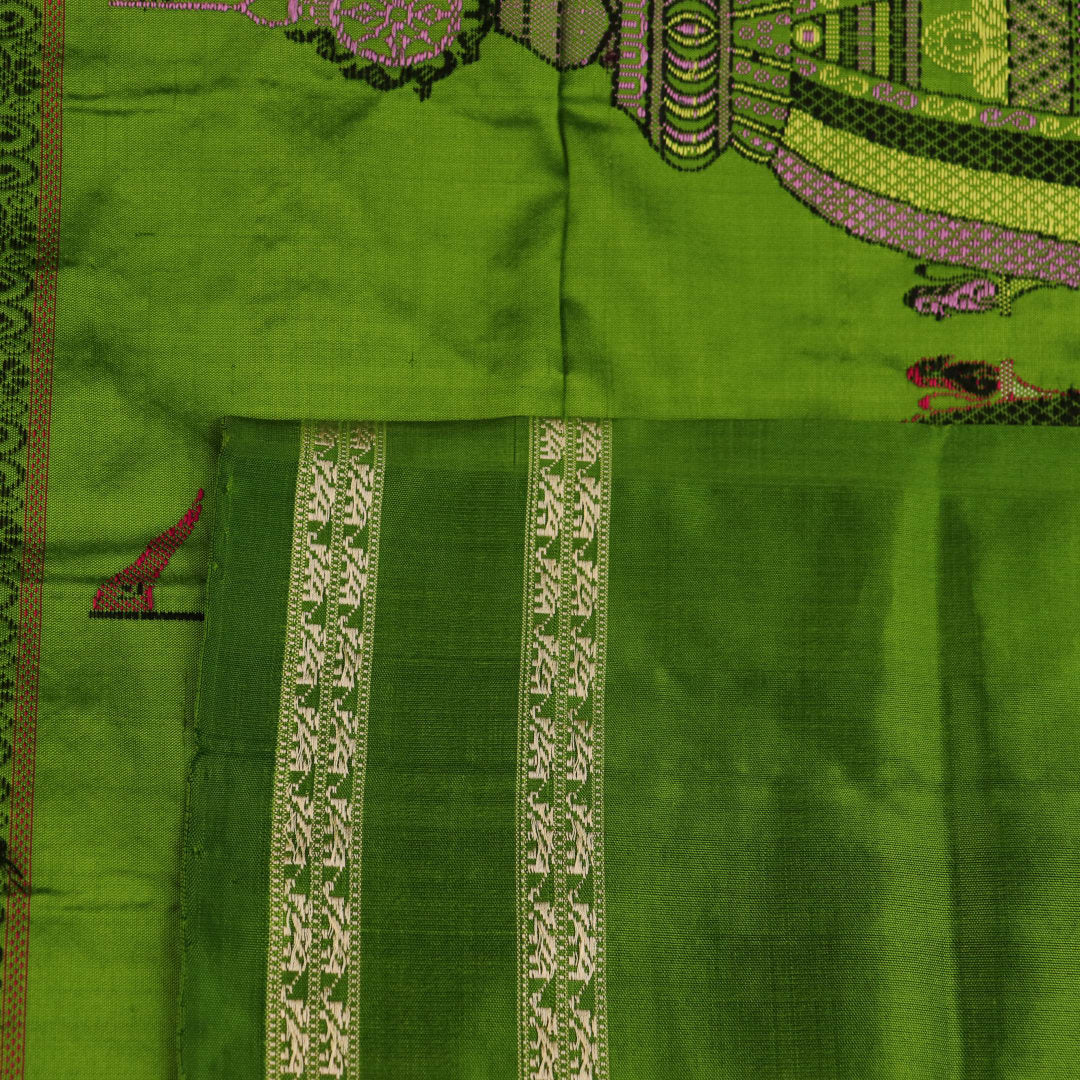 Close-up of cream and green Bomkai Silk Saree fabric texture with butta pattern.