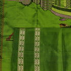 Close-up of cream and green Bomkai Silk Saree fabric texture with butta pattern.