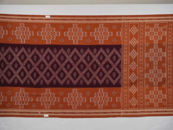 Model draped in a maroon and brown Sambalpuri cotton saree showcasing traditional Odisha handloom style.