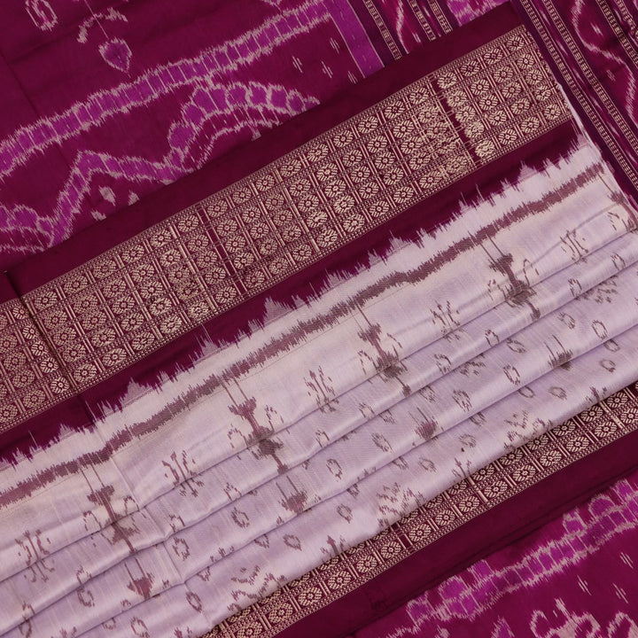 Close-up of silk fabric with intricate Sambalpuri motif design in multicolor and purple hues