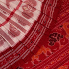 Full view of a white and red Sambalpuri cotton saree with traditional motifs.